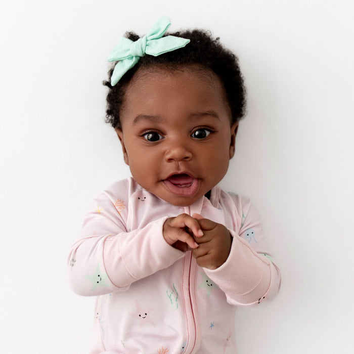 Starfish print bamboo baby romper flat lay