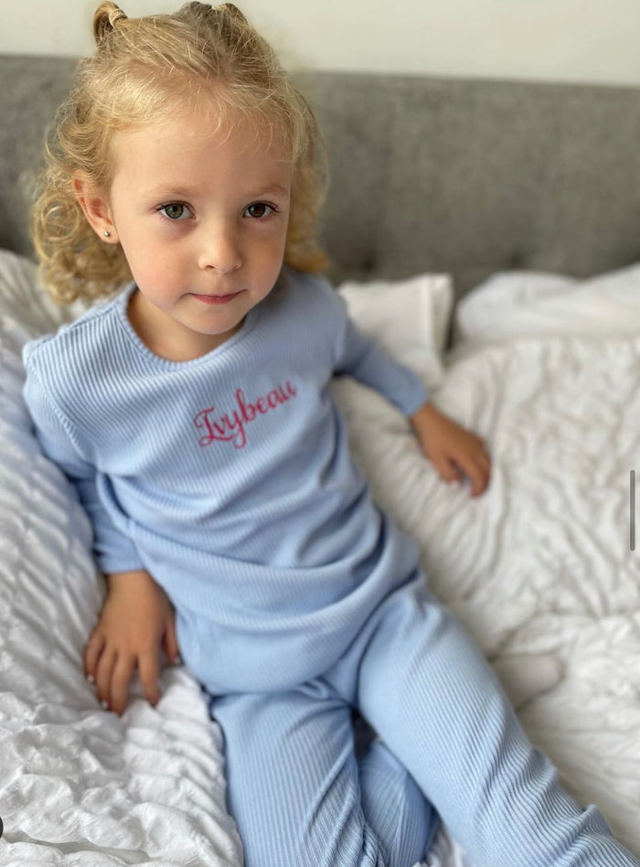 girl wearing Blue Ribbed Childrens Tracksuit with pin embroidery