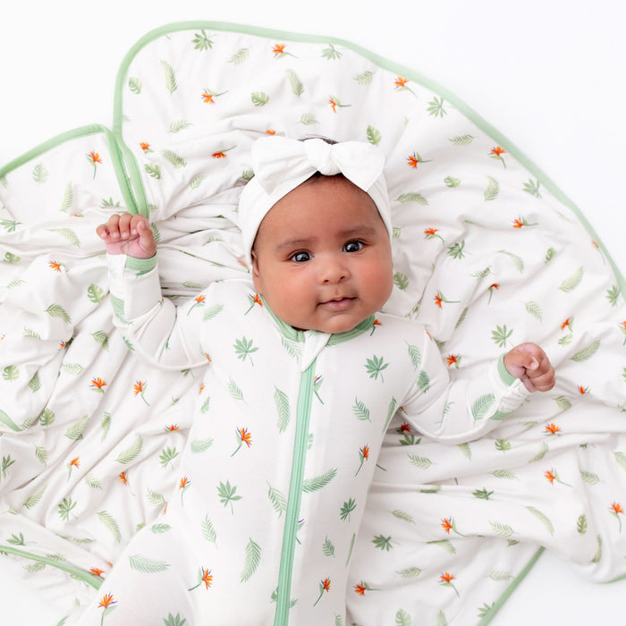 Baby wearing bird of paradise bamboo footie, lifestyle photo