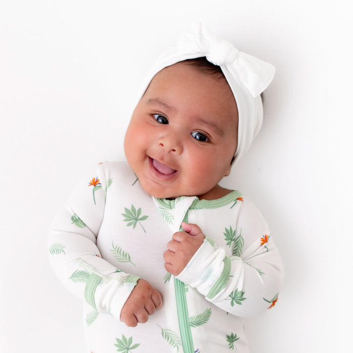 Close-up of bird of paradise print on baby footie