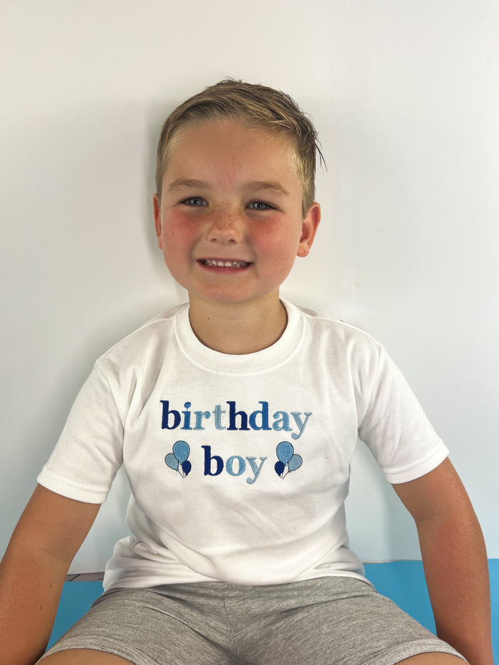 Boy wearing an embroidered birthday boy t-shirt