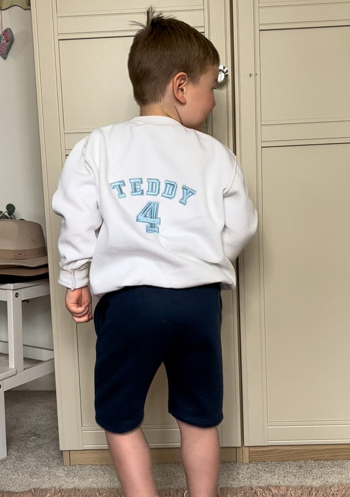 Back of boys jumper with blue embroidery