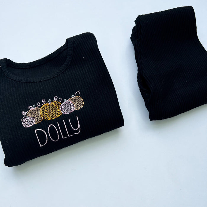 black loungewear with pink and orange pumpkin design with childs name in pink