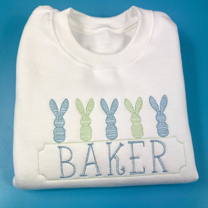 White sweatshirt with green and blue bunny embroidery design