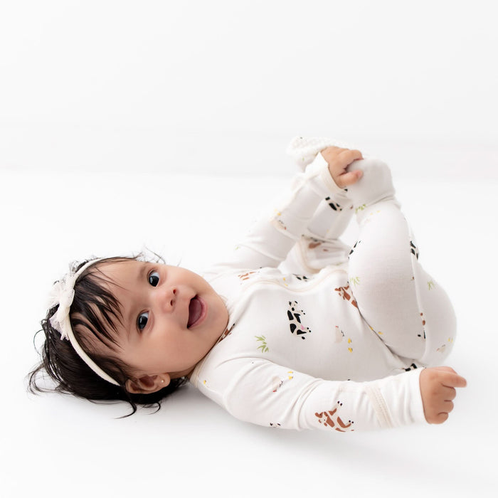 Close-up of zipper on cow print bamboo baby footie