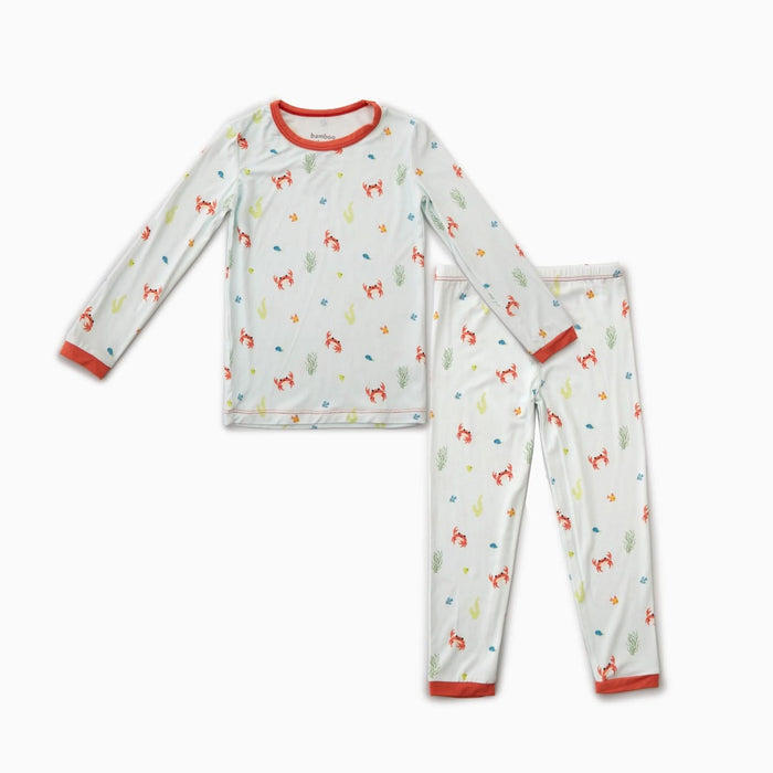 A toddler's pajama set with long-sleeved top and matching pants, featuring a multicolored crab pattern and a orange trim.
