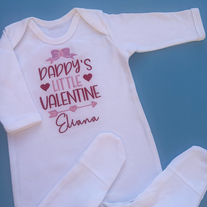 White romper with daddy’s little Valentine embroidered on the front