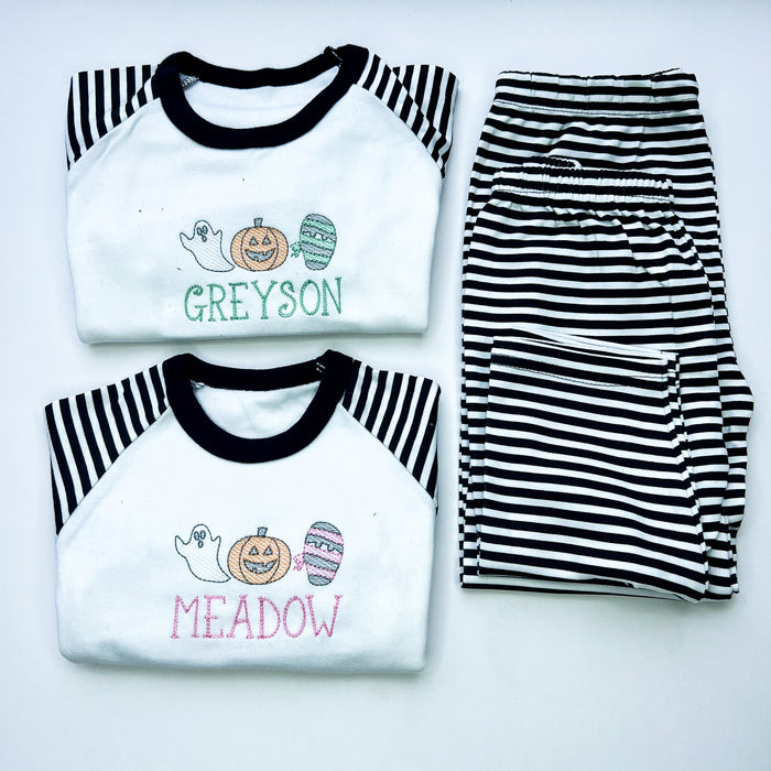 sketch design halloween pyjamas for girls and boys. embroidered with a ghost, mummy and pumpkin and finished with child's name