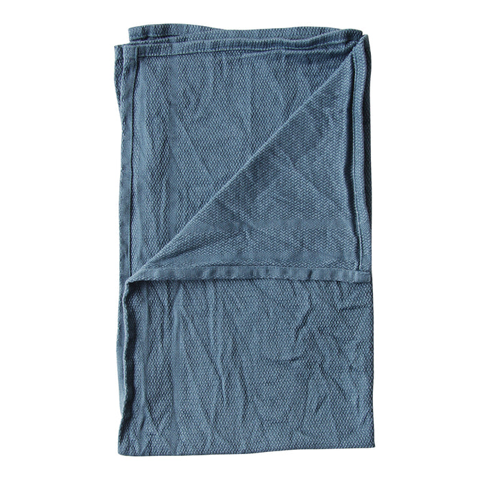 Folded blue textured towel on a white background