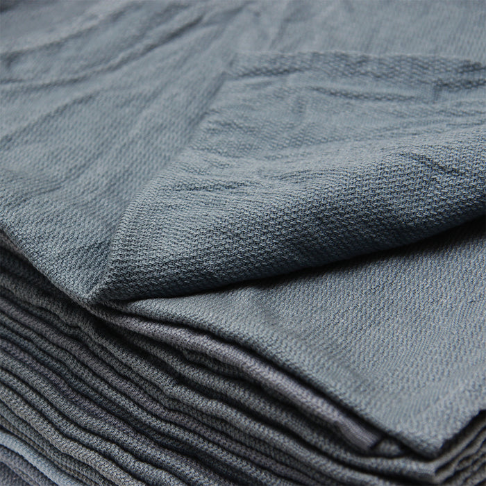 Stack of folded blue gray fabric with a textured surface