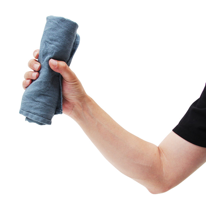 Hand holding a blue towel against a white background