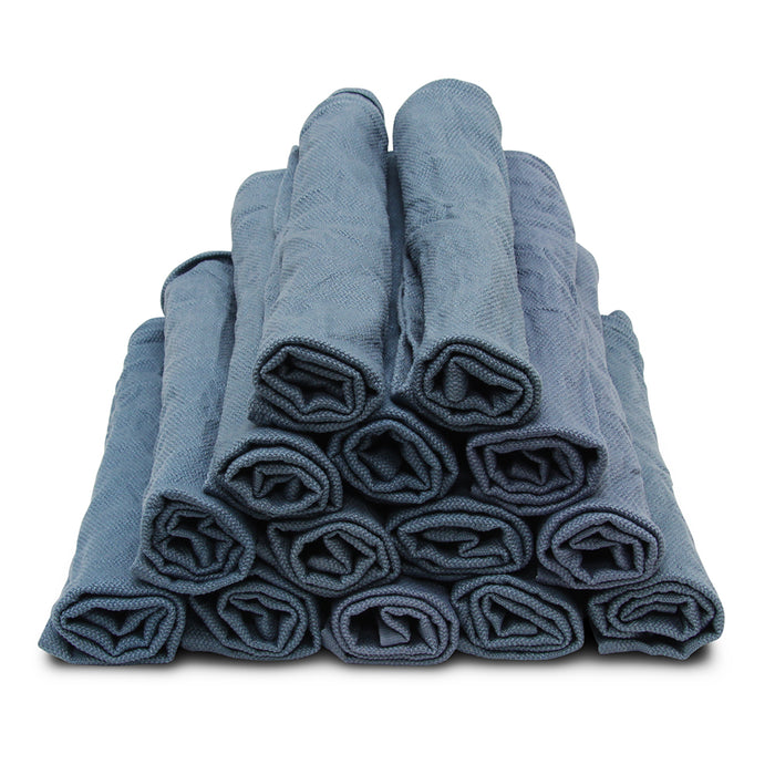 Stack of rolled-up blue towels on a white background