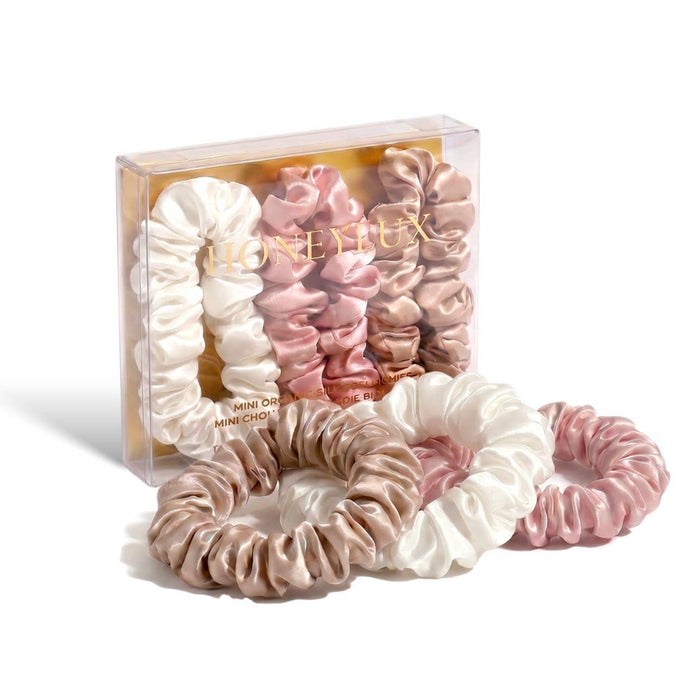 Set of pink and white scrunchies with 'Honeylux' branding on a white background