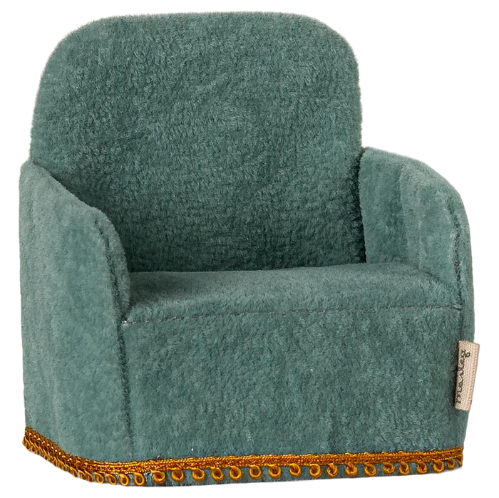 A green folding chair toy designed for small children, with a plush texture and decorative trim around the seat.
