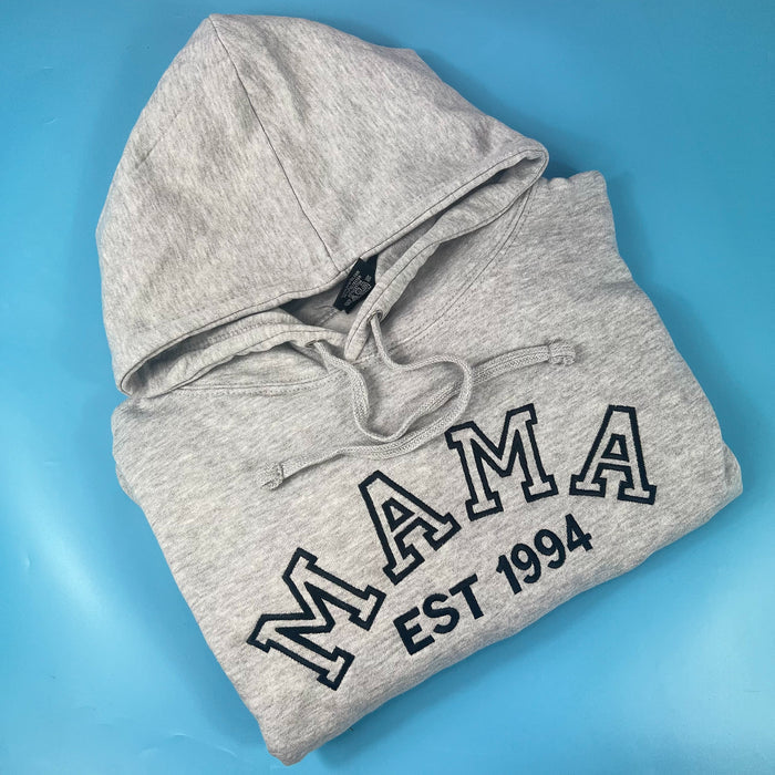 A gray sweatshirt with 'mama' and a number '1994' printed on the front.