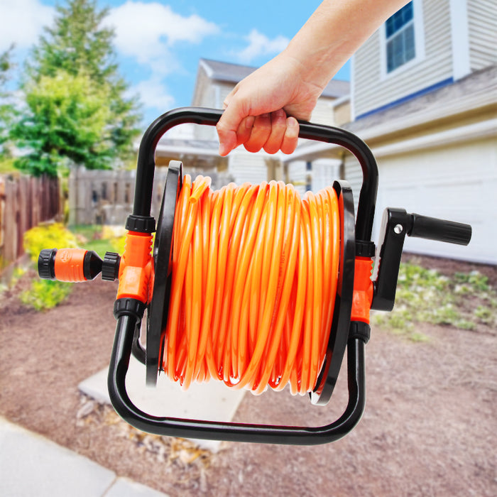 Person holding an orange garden hose reel with a house and trees in the background