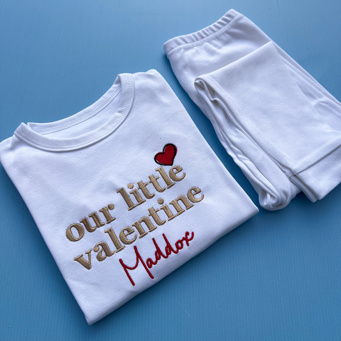 White pyjamas with our little valentine embroidered on the front