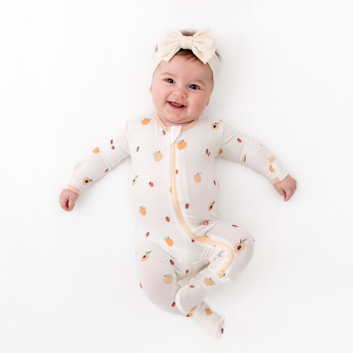 Close-up of zipper on peach bamboo baby footie pajama