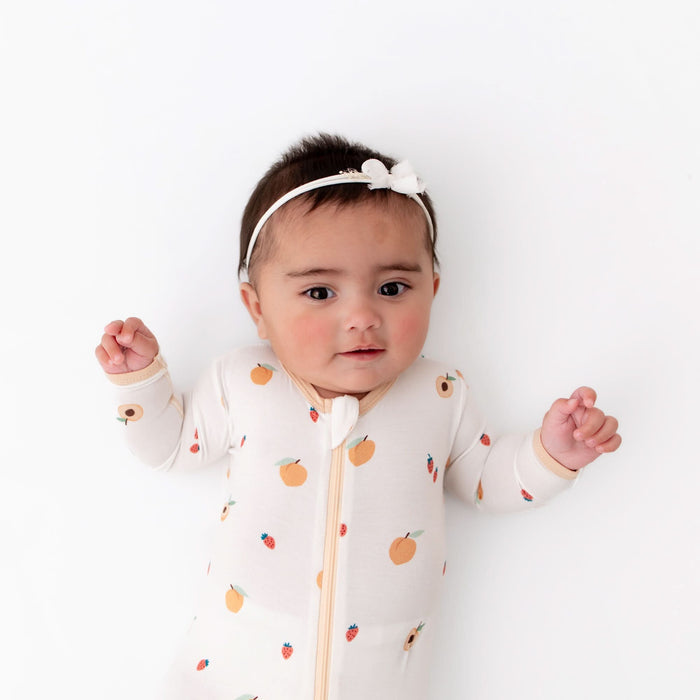 Baby wearing peach bamboo zippered footie pajama