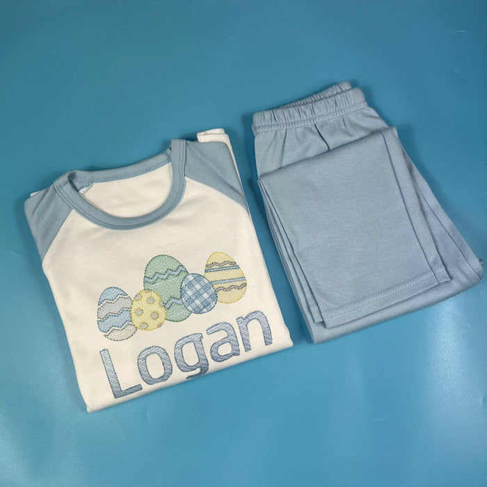 Blue and white pyjamas with an Easter egg design on the front and child’s name embroidered