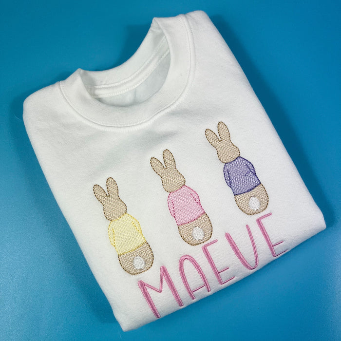 White sweatshirt with embroidered rabbits