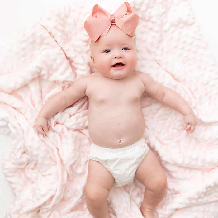 Pink cozy cloud bamboo baby blanket, lifestyle shot