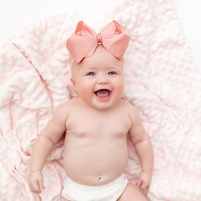 Baby with pink bamboo cloud blanket