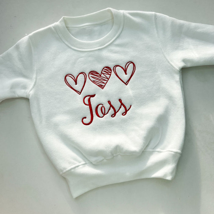 White jumper with red love heart embroidery