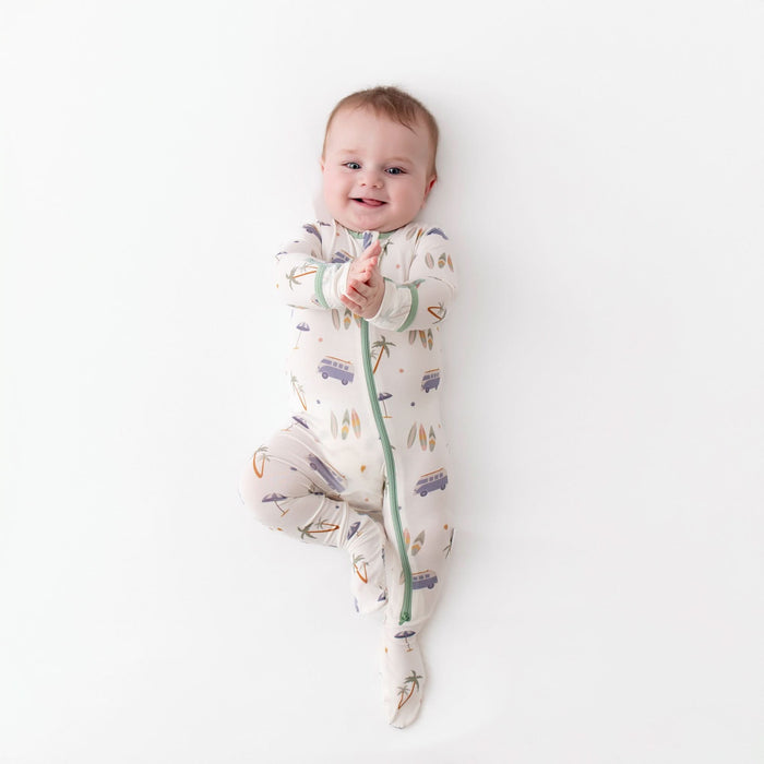 Surfboards zippered footie flat lay, bamboo baby pajama