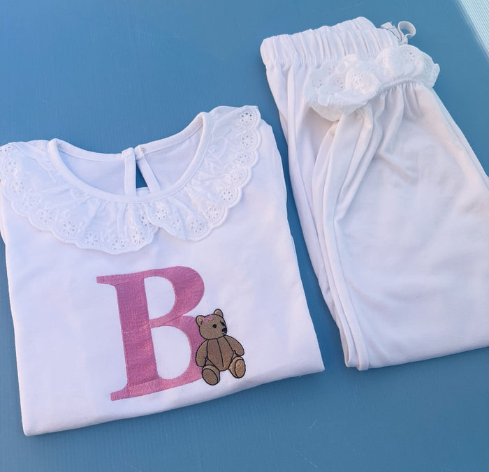 White frill pyjamas with a big pink B with a traditional bear embroidered