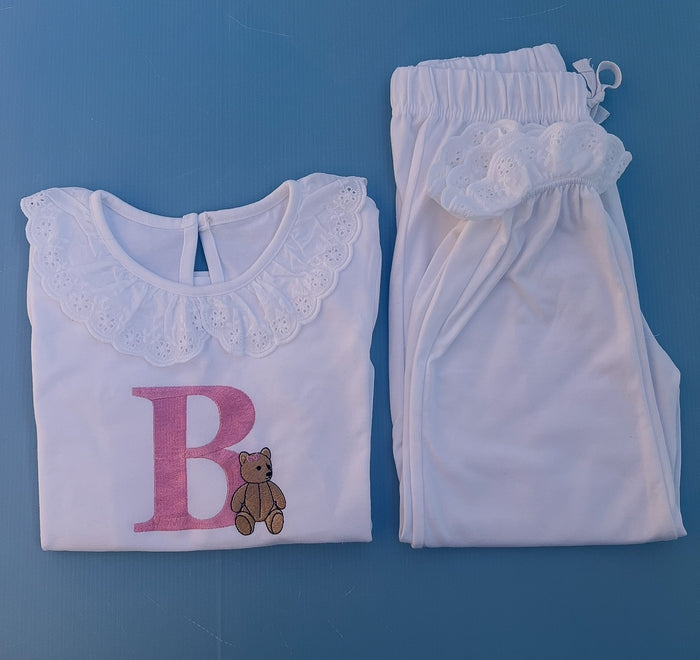 White frill pyjamas with a big pink B with a traditional bear embroidered