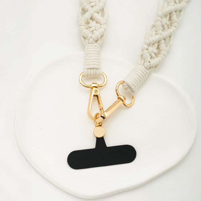 Close up shot of the golden clips and adaptor card from the natural-colored macramé crossbody strap for mobile phones | Gifts against human trafficking