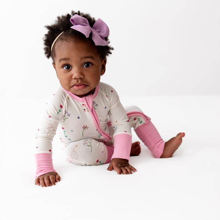Close-up of wildflowers print on baby romper