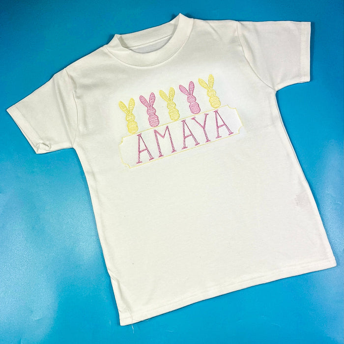 Pink and yellow embroidered Easter design on a tshirt